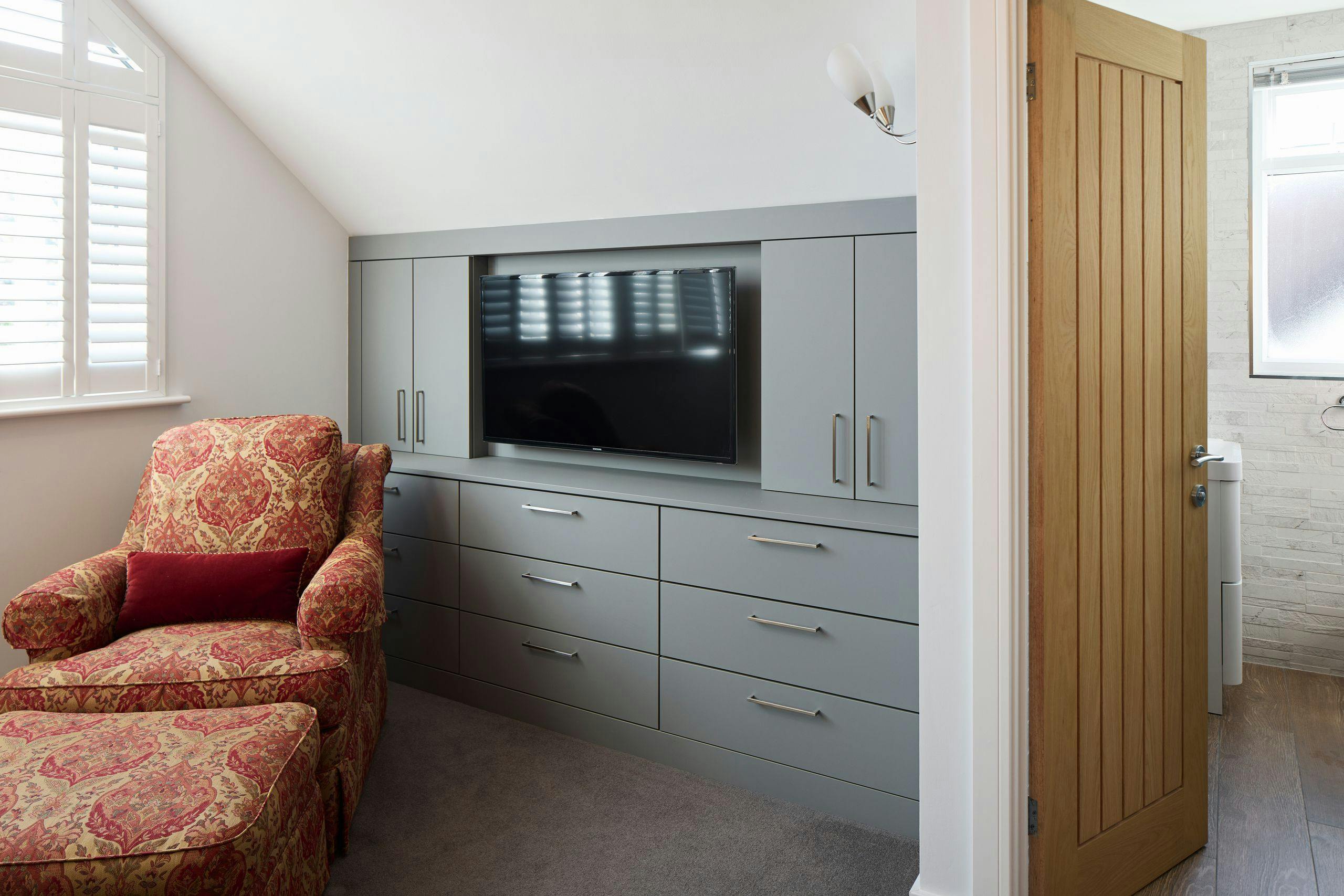 Fitted bedroom furniture with drawers, cupboards and integrated TV mount