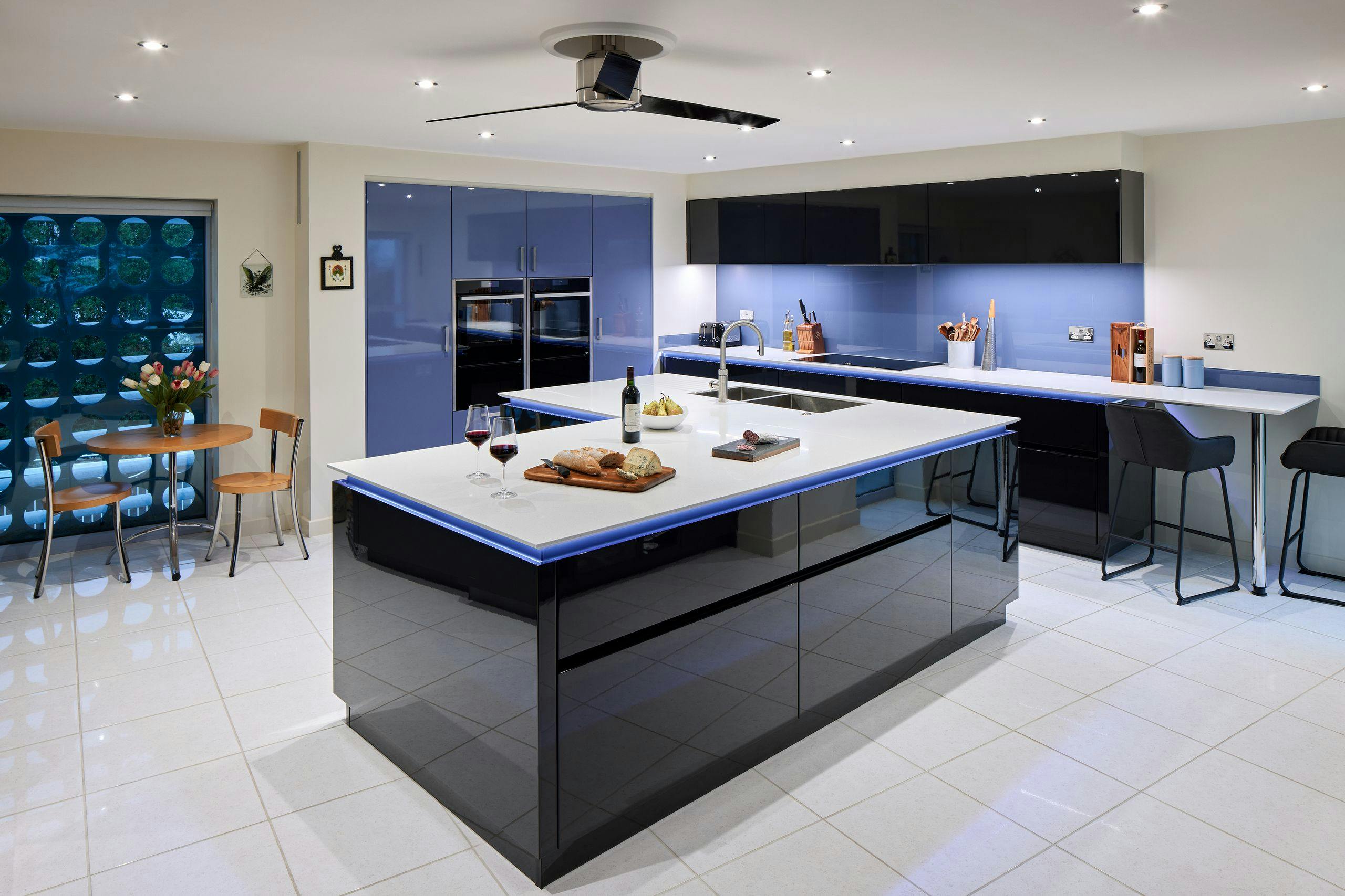 Gloss black and blue contemporary apartment kitchen