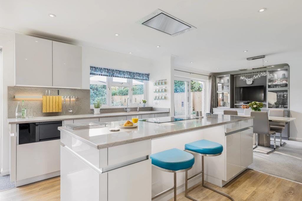 Handleless white gloss kitchen-living space