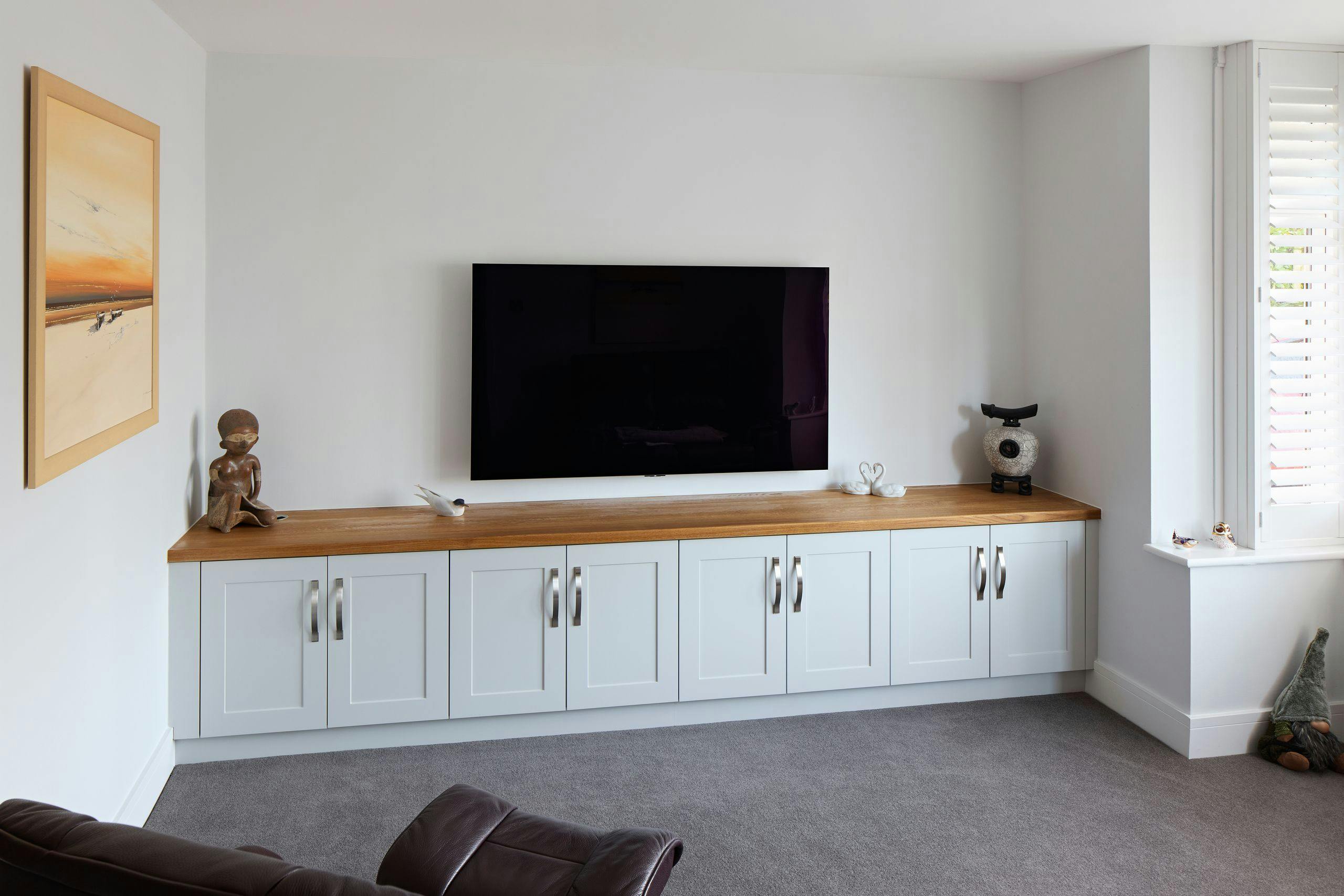 Fitted living room television unit with oak top and painted shaker doors