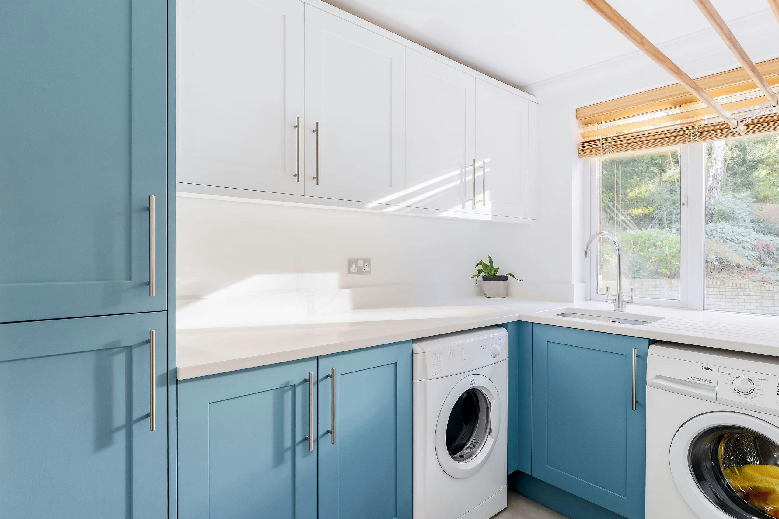 Bespoke hand-painted shaker utility room with washing machine and tumble dryer