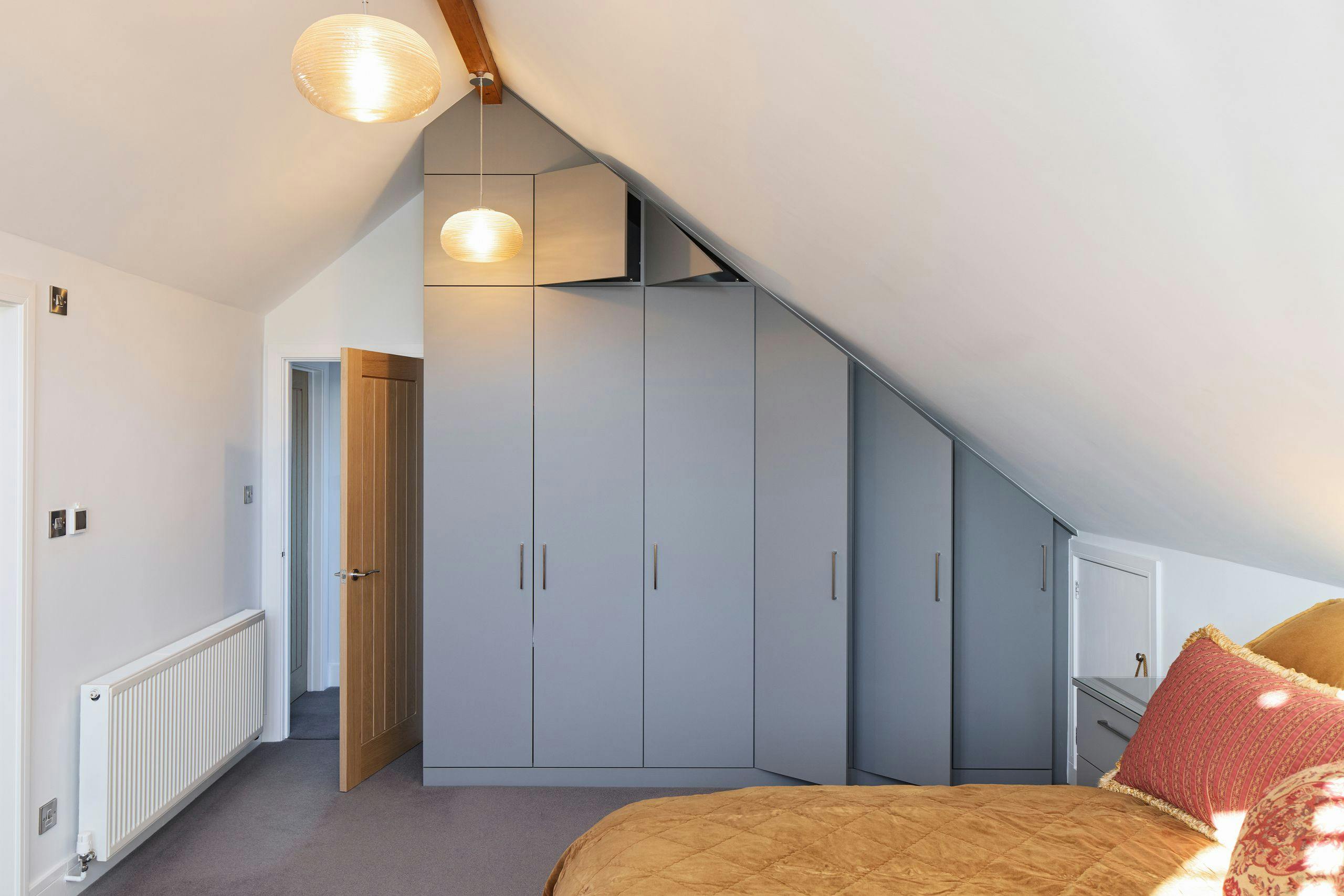 Custom fitted bedroom wardrobe scribed to fit attic ceiling